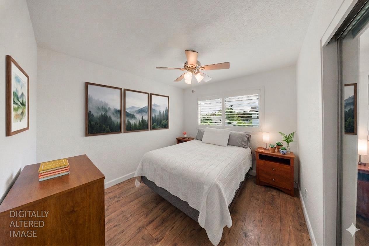 1325 Forest Drive Turlock, CA 95380 - Photo 22 of 28 a bedroom with a large bed and a chandelier