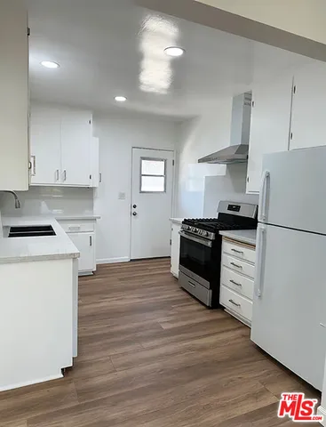 a kitchen with sink and cabinets