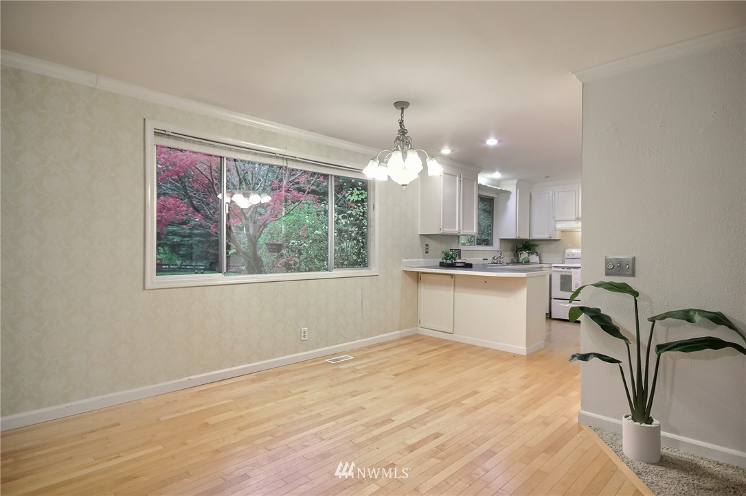 4321 196th Street Southeast Bothell, WA 98012 - Photo 11 of 40 a view of a kitchen with a sink cabinets and wooden floor
