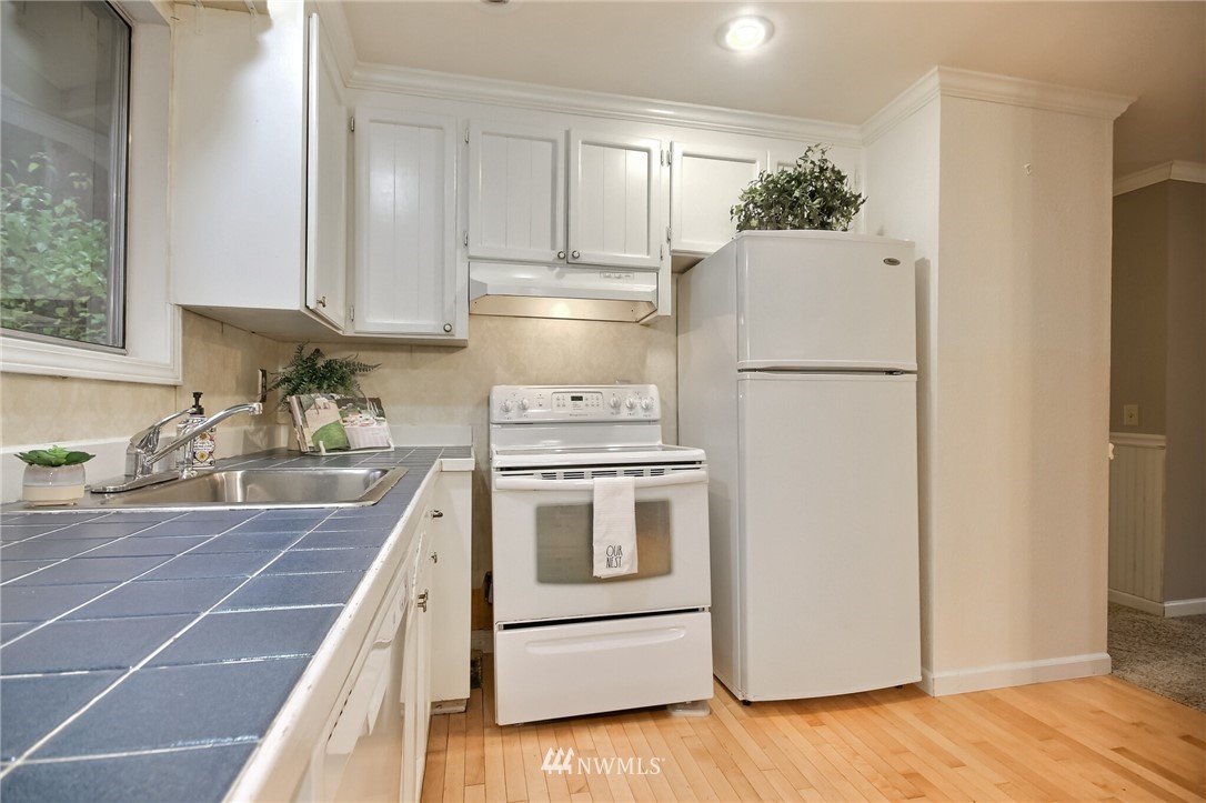4321 196th Street Southeast Bothell, WA 98012 - Photo 16 of 40 a kitchen with appliances a sink and a cabinets