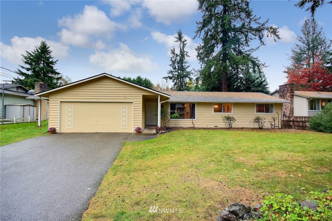 4321 196th Street Southeast Bothell, WA 98012 - Photo 3 of 40 a view of a house with a yard and large tree