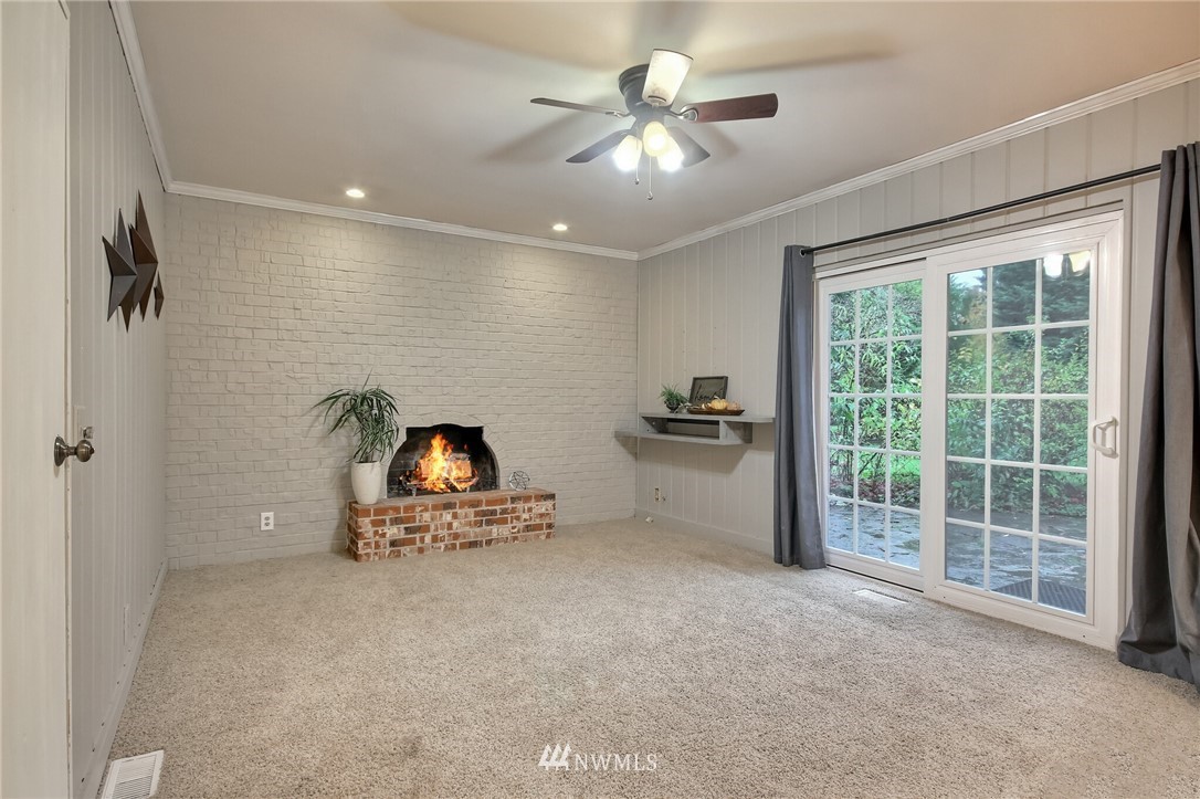 4321 196th Street Southeast Bothell, WA 98012 - Photo 21 of 40 a view of a livingroom with a ceiling fan and a large window