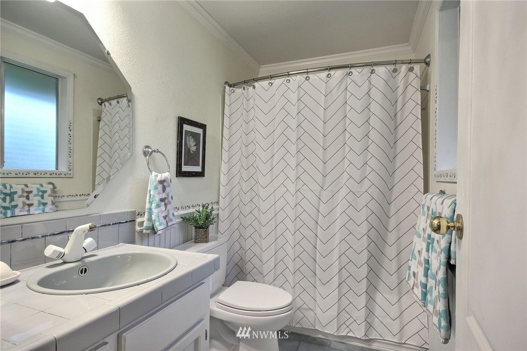 4321 196th Street Southeast Bothell, WA 98012 - Photo 28 of 40 a bathroom with a sink a toilet and a mirror