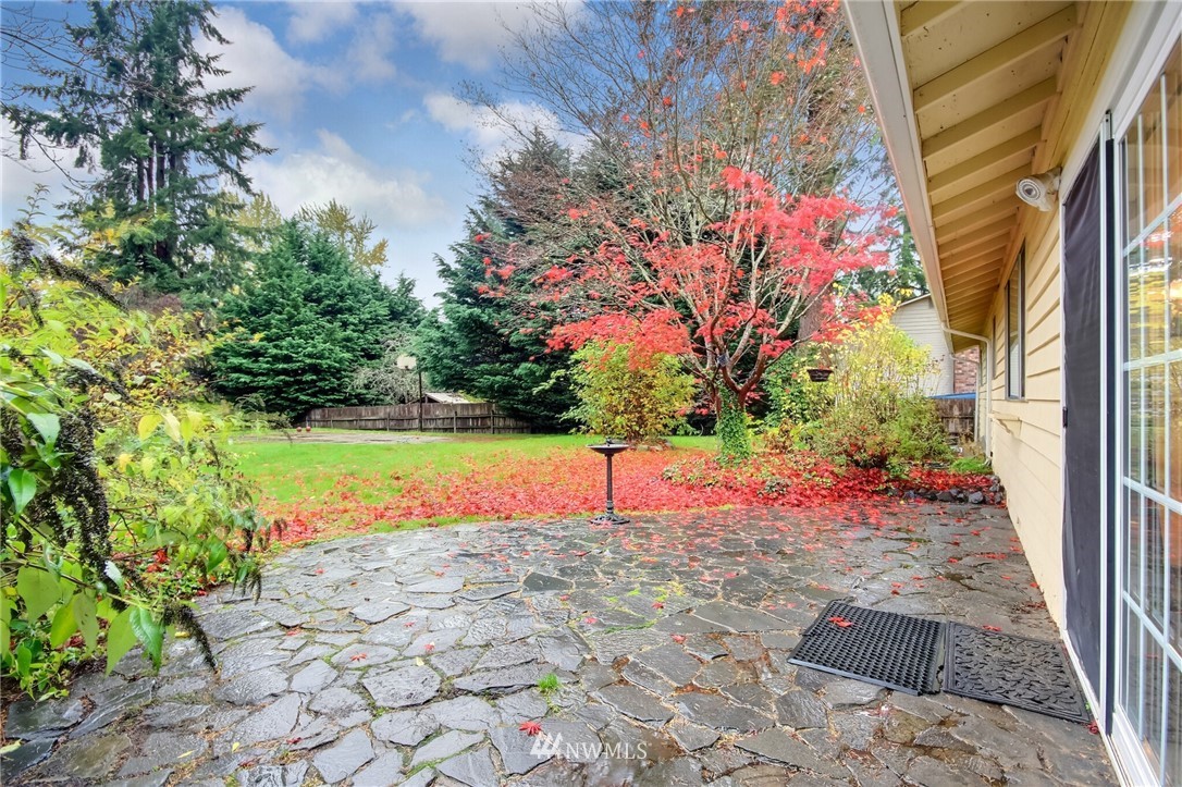 4321 196th Street Southeast Bothell, WA 98012 - Photo 38 of 40 a view of yellow house with a yard and potted plants