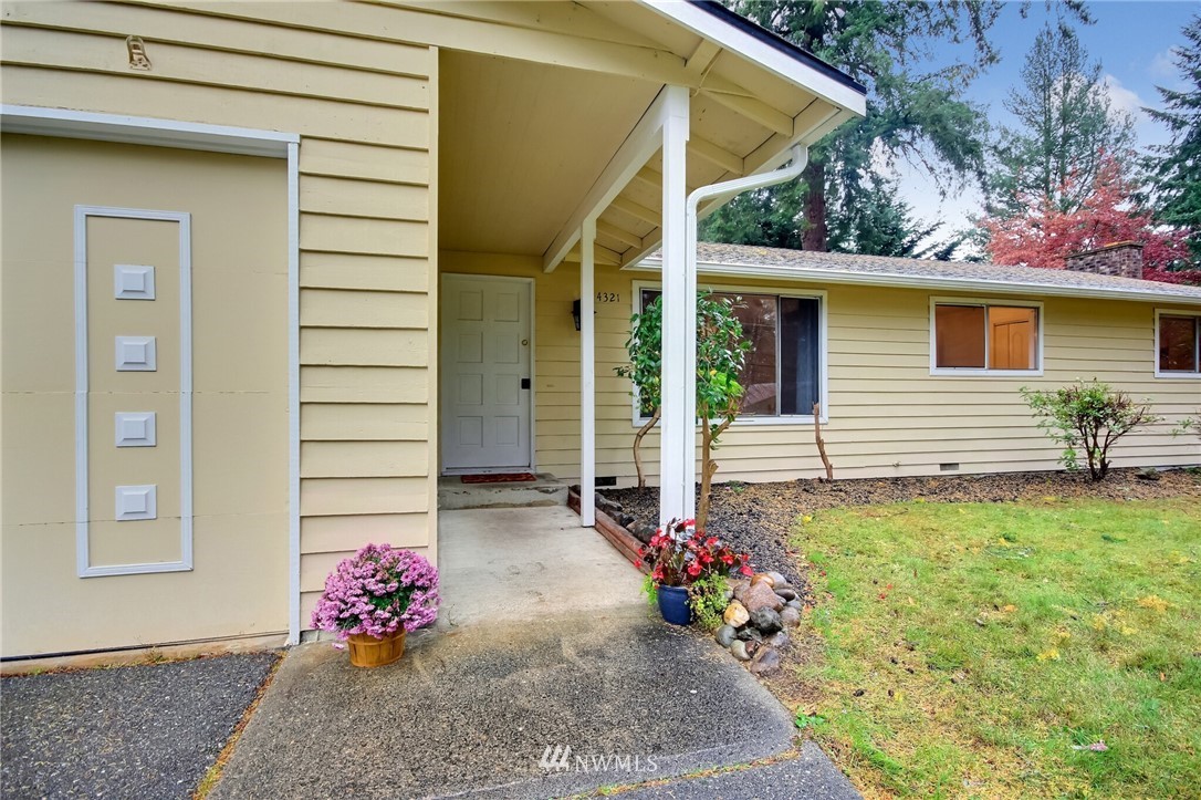 4321 196th Street Southeast Bothell, WA 98012 - Photo 5 of 40 a flower garden is sitting in front of a house