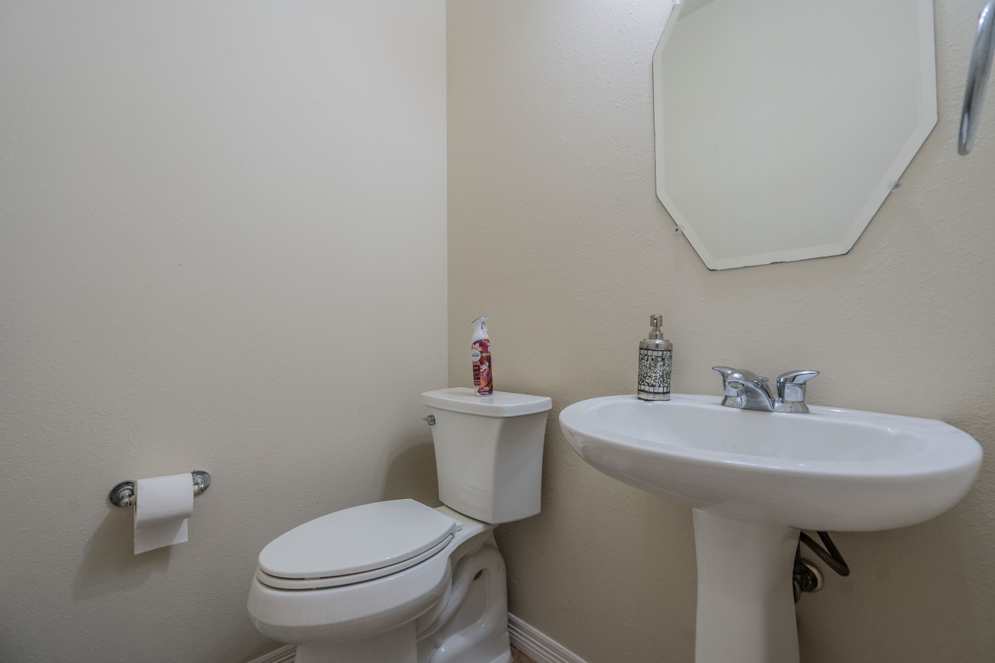 24139 Spring Sunset Drive Spring, TX 77373 - Photo 22 of 26 a bathroom with a sink a toilet and a mirror