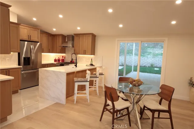 a dining room with furniture and a kitchen view