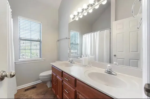 a bathroom with a sink double vanity and a mirror