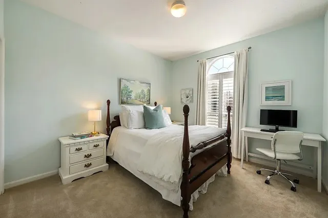a bedroom with a bed and a chair in it