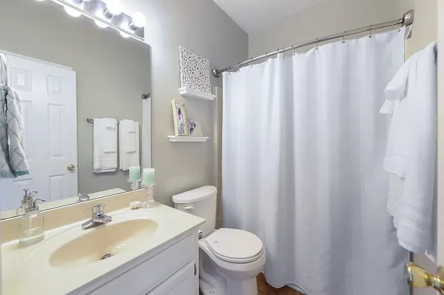 a bathroom with a sink toilet and shower