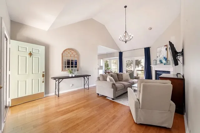 a living room with furniture a bed and a chandelier