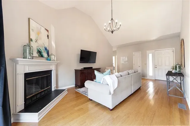 a living room with furniture a fireplace and a flat screen tv