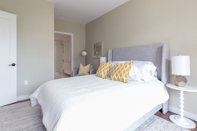 a bedroom with a bed and a lamp