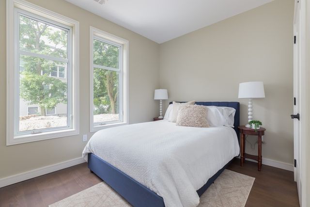 a bedroom with a bed and a lamp next to a window