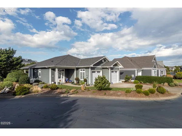 a front view of house with yard and trees around