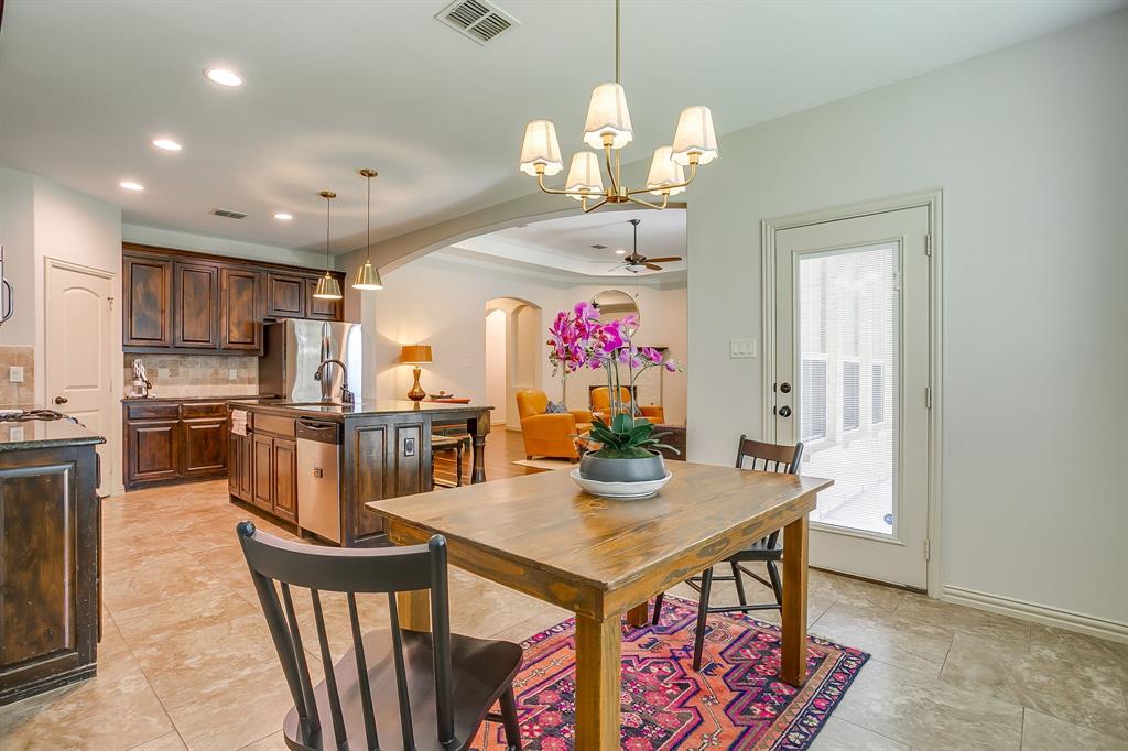 3936 Brookdale Road Benbrook, TX 76116 - Photo 18 of 40 a view of a dining room with furniture and a chandelier