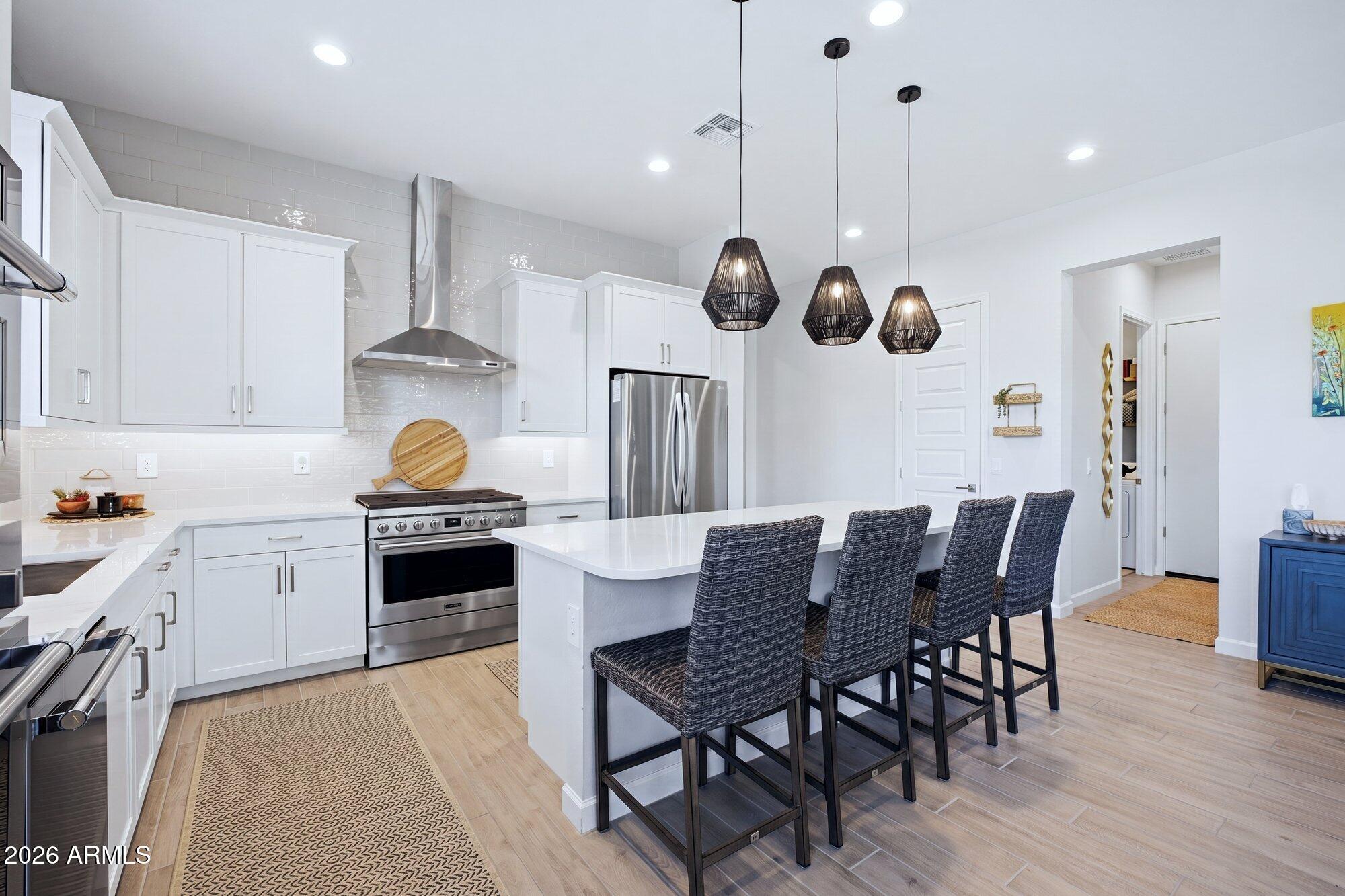5963 East Lone Cactus Road Phoenix, AZ 85054 - Photo 6 of 22 a kitchen with a table and chairs in it