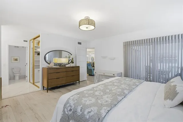 a bedroom with a bed and a dresser