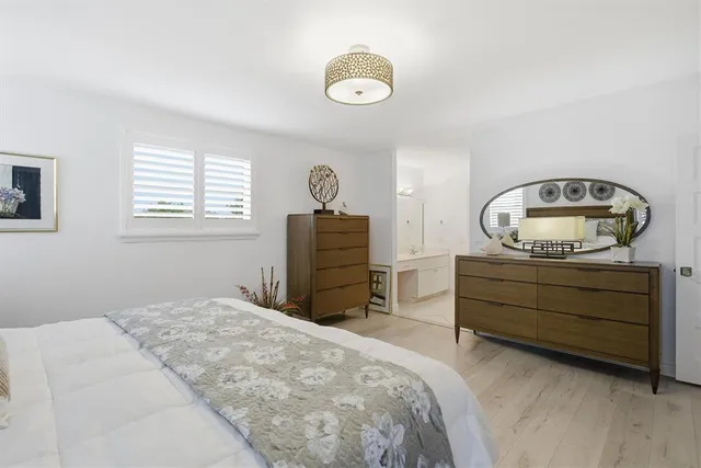 a bed room with a bed and a dresser