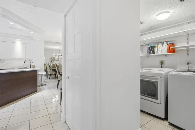 a utility room with cabinets washer and dryer