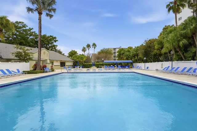 a view of a swimming pool with an outdoor seating