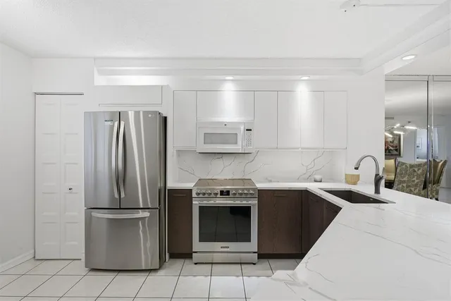 a kitchen with a sink and stainless steel appliances