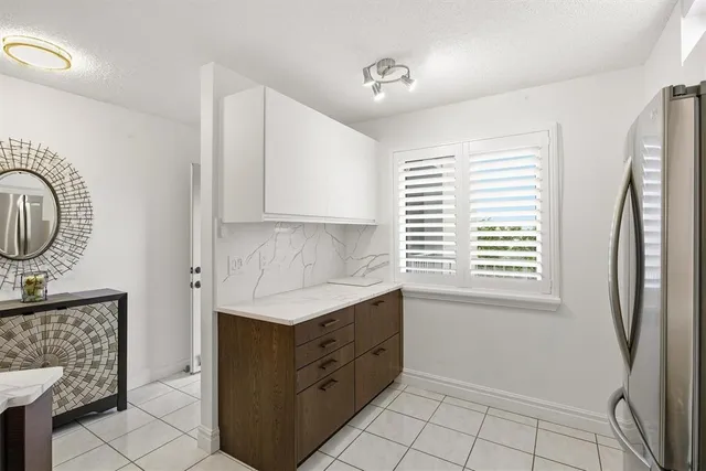 a kitchen with stainless steel appliances a sink cabinets and a window