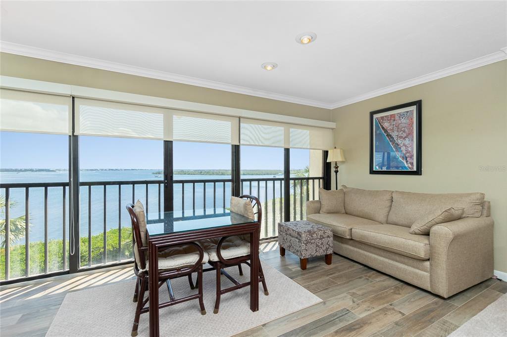 1591 Beach Road, Unit 403 Englewood, FL 34223 - Photo 13 of 61 a living room with furniture wooden floor and a window