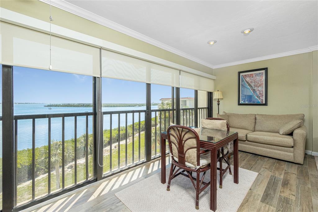 1591 Beach Road, Unit 403 Englewood, FL 34223 - Photo 16 of 61 a living room with furniture a table and a large window