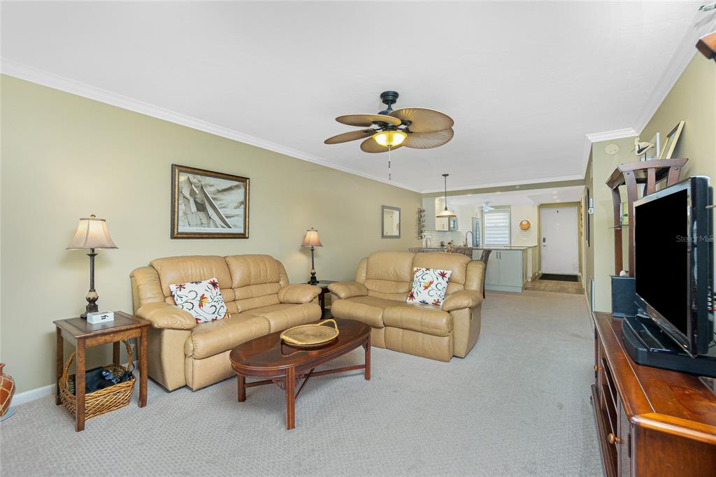 1591 Beach Road, Unit 403 Englewood, FL 34223 - Photo 17 of 61 a living room with furniture and a flat screen tv