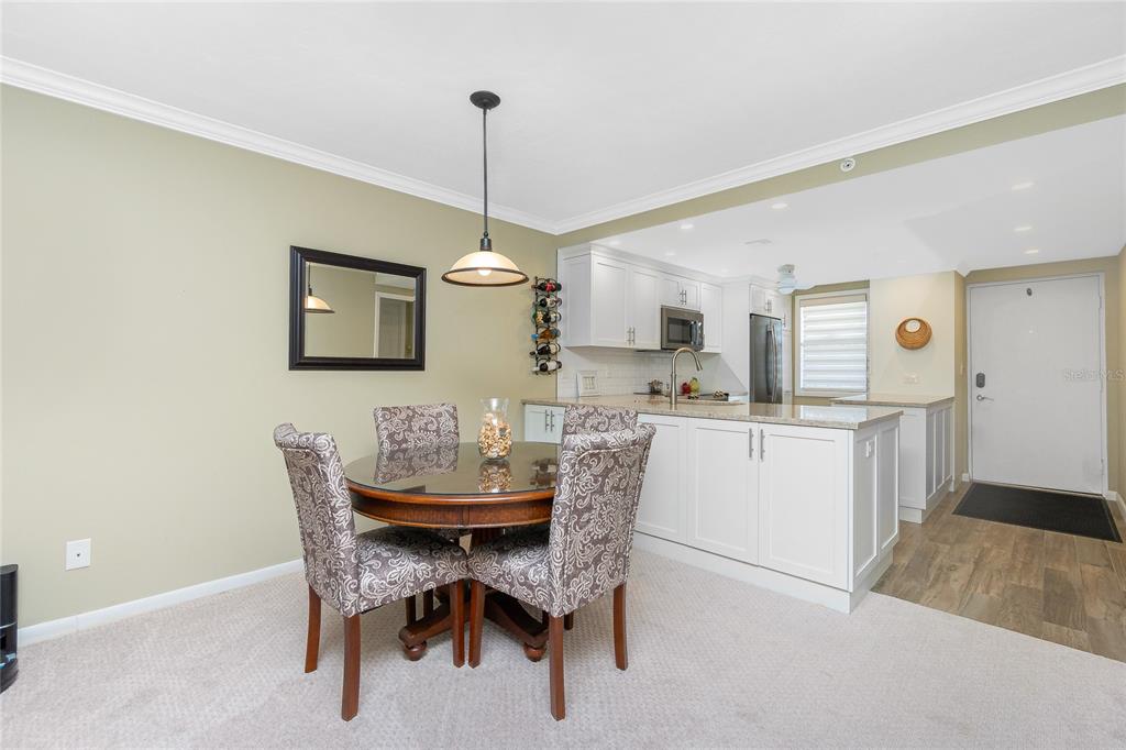 1591 Beach Road, Unit 403 Englewood, FL 34223 - Photo 18 of 61 a view of a dining room with furniture