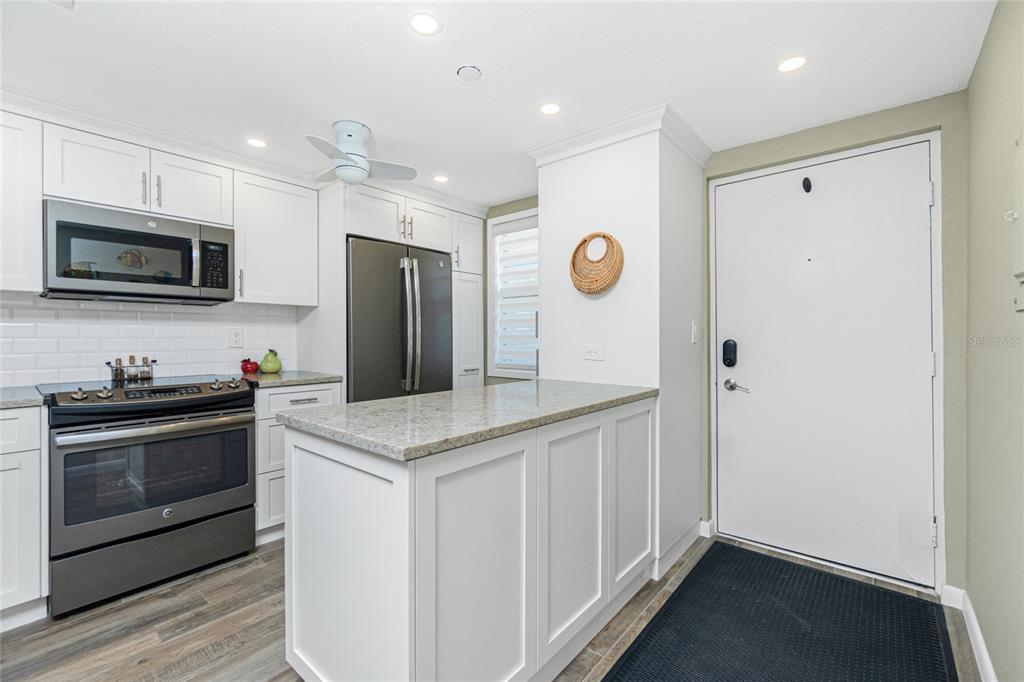 1591 Beach Road, Unit 403 Englewood, FL 34223 - Photo 19 of 61 a kitchen with a sink and a stove top oven