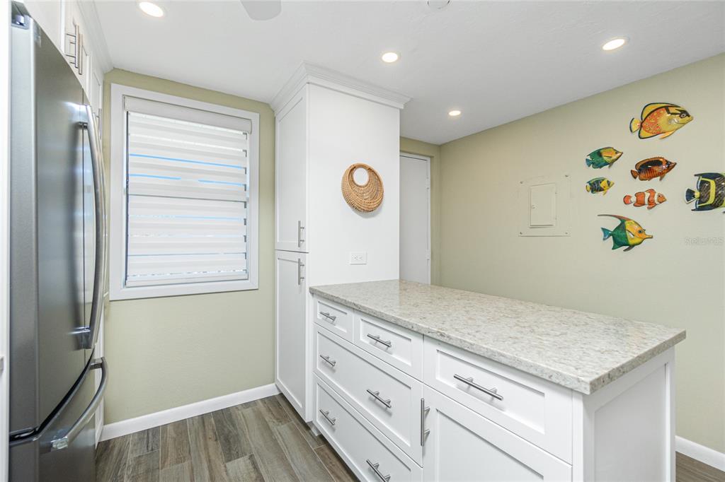 1591 Beach Road, Unit 403 Englewood, FL 34223 - Photo 22 of 61 a view of kitchen island with wooden floor