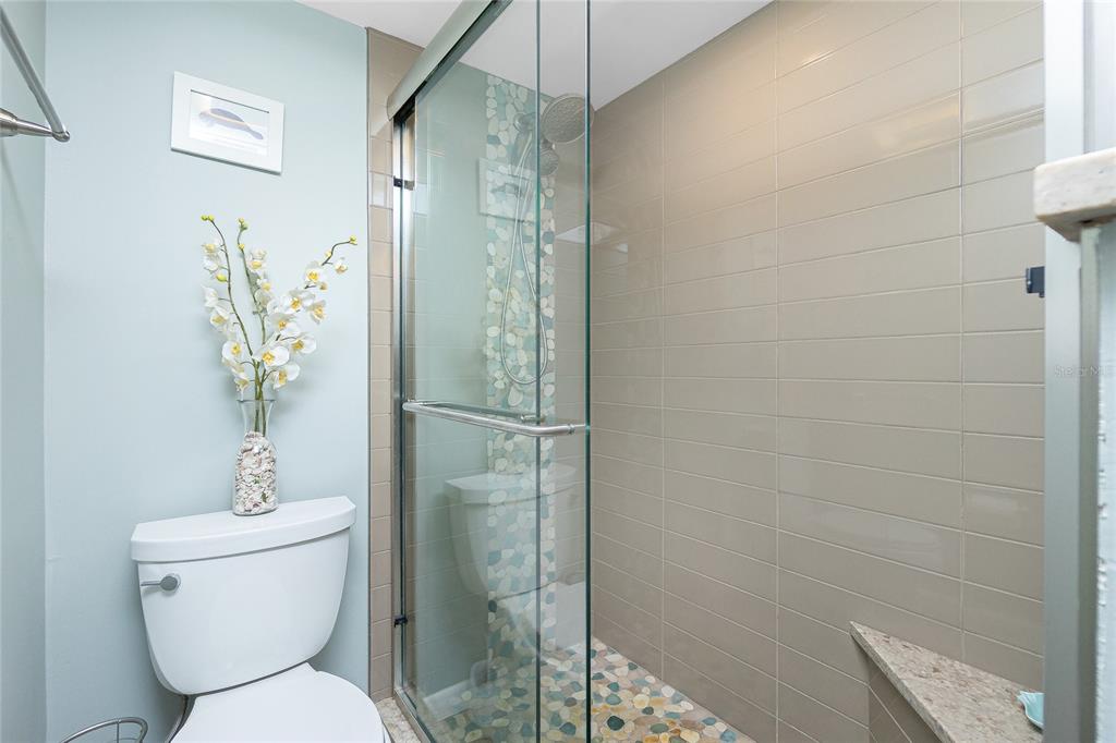 1591 Beach Road, Unit 403 Englewood, FL 34223 - Photo 28 of 61 a bathroom with a toilet and shower