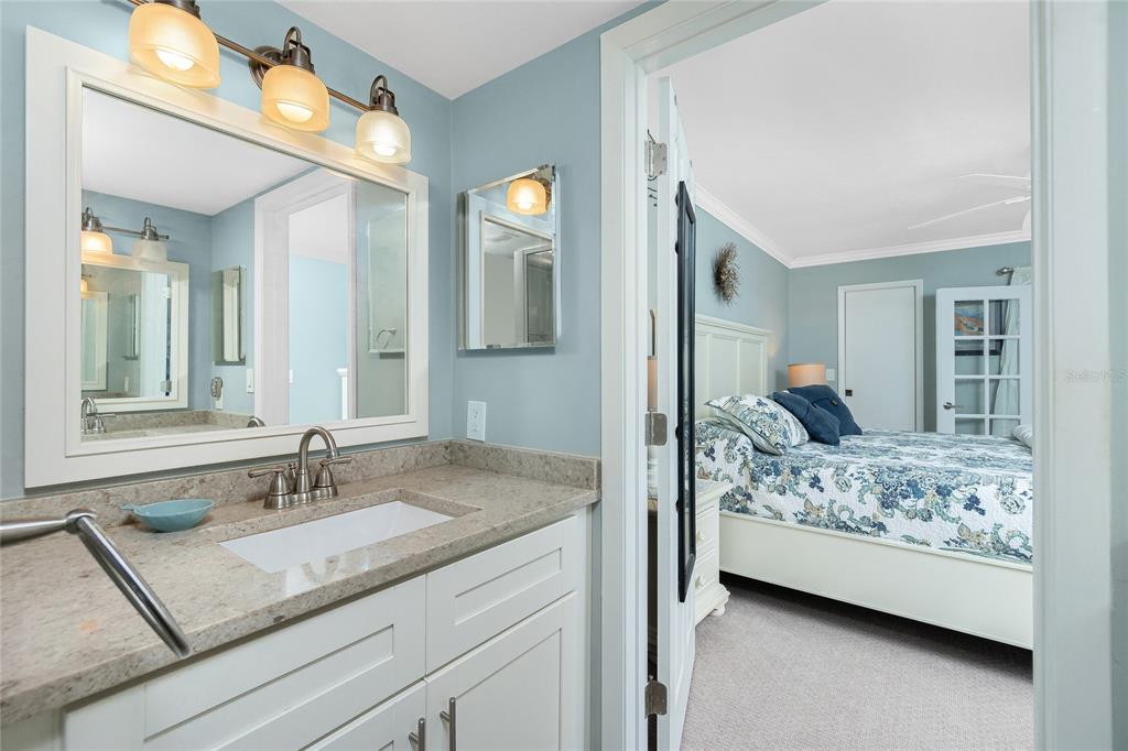 1591 Beach Road, Unit 403 Englewood, FL 34223 - Photo 29 of 61 a en suite bathroom with a granite countertop sink and a mirror