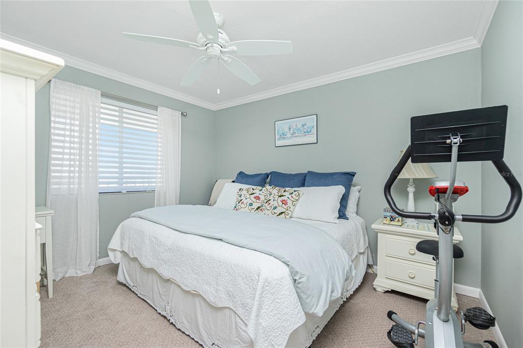 1591 Beach Road, Unit 403 Englewood, FL 34223 - Photo 30 of 61 a bedroom with a bed and a chandelier