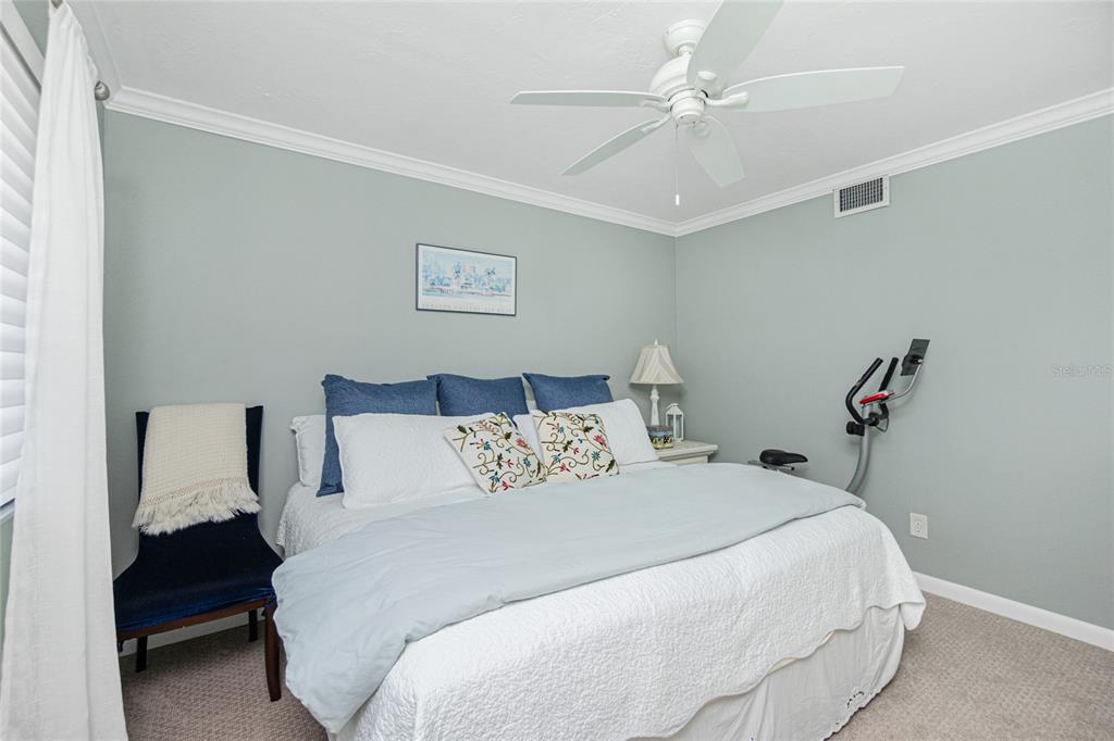 1591 Beach Road, Unit 403 Englewood, FL 34223 - Photo 31 of 61 a bedroom with a bed and a chandelier