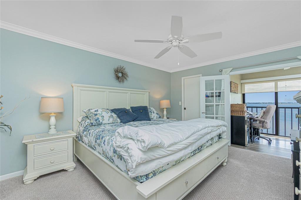 1591 Beach Road, Unit 403 Englewood, FL 34223 - Photo 4 of 61 a bedroom with a bed and ceiling fan