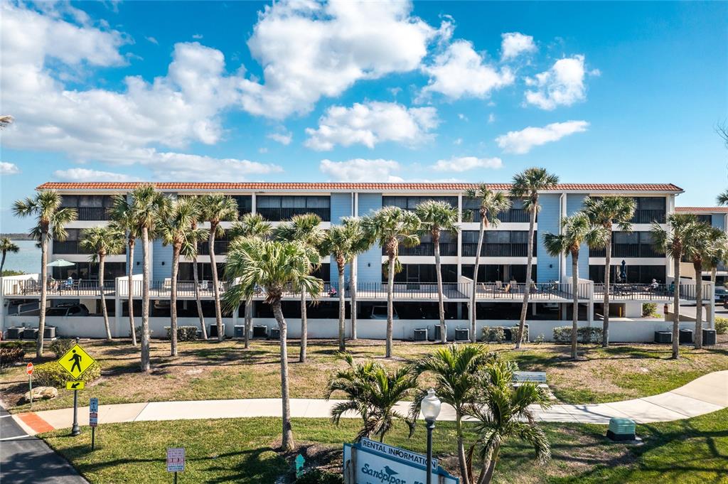 1591 Beach Road, Unit 403 Englewood, FL 34223 - Photo 47 of 61 a view of a swimming pool with outdoor seating