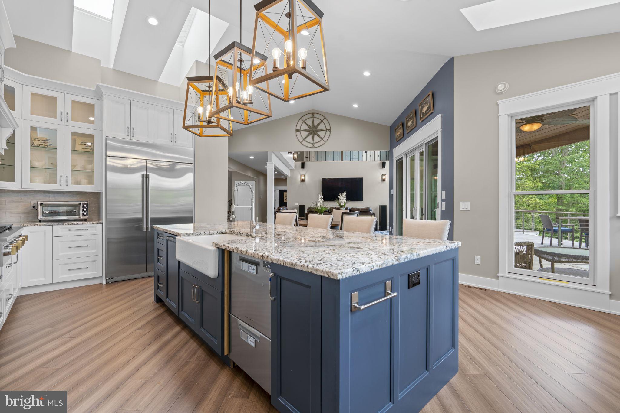798 Creek View Road Severna Park, MD 21146 - Photo 17 of 72 a kitchen with stainless steel appliances granite countertop a sink dishwasher a stove and a dining table with wooden floor