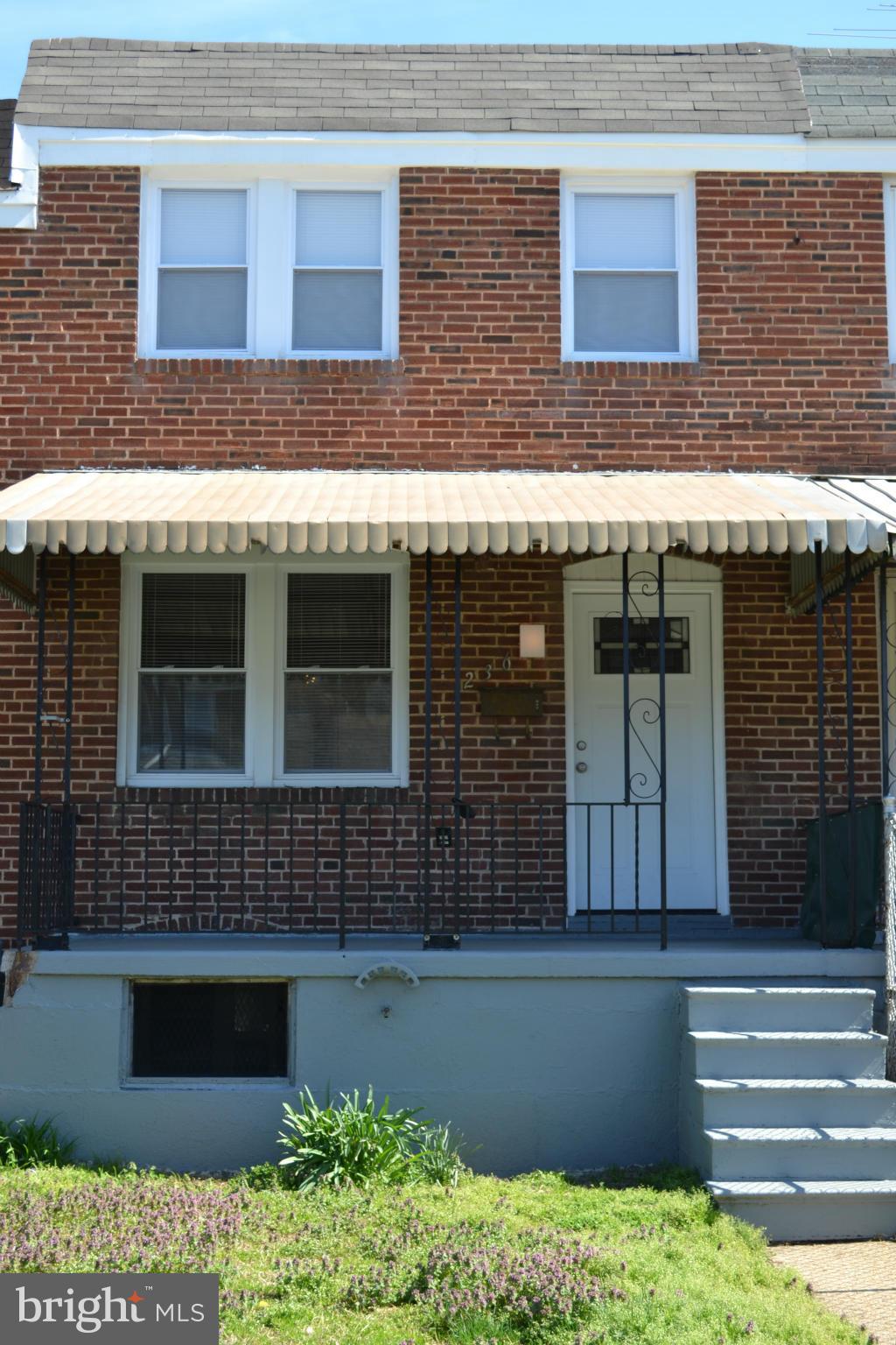 236 West Edgevale Road Baltimore, MD 21225 - Photo 1 of 30 a front view of a building with a garden