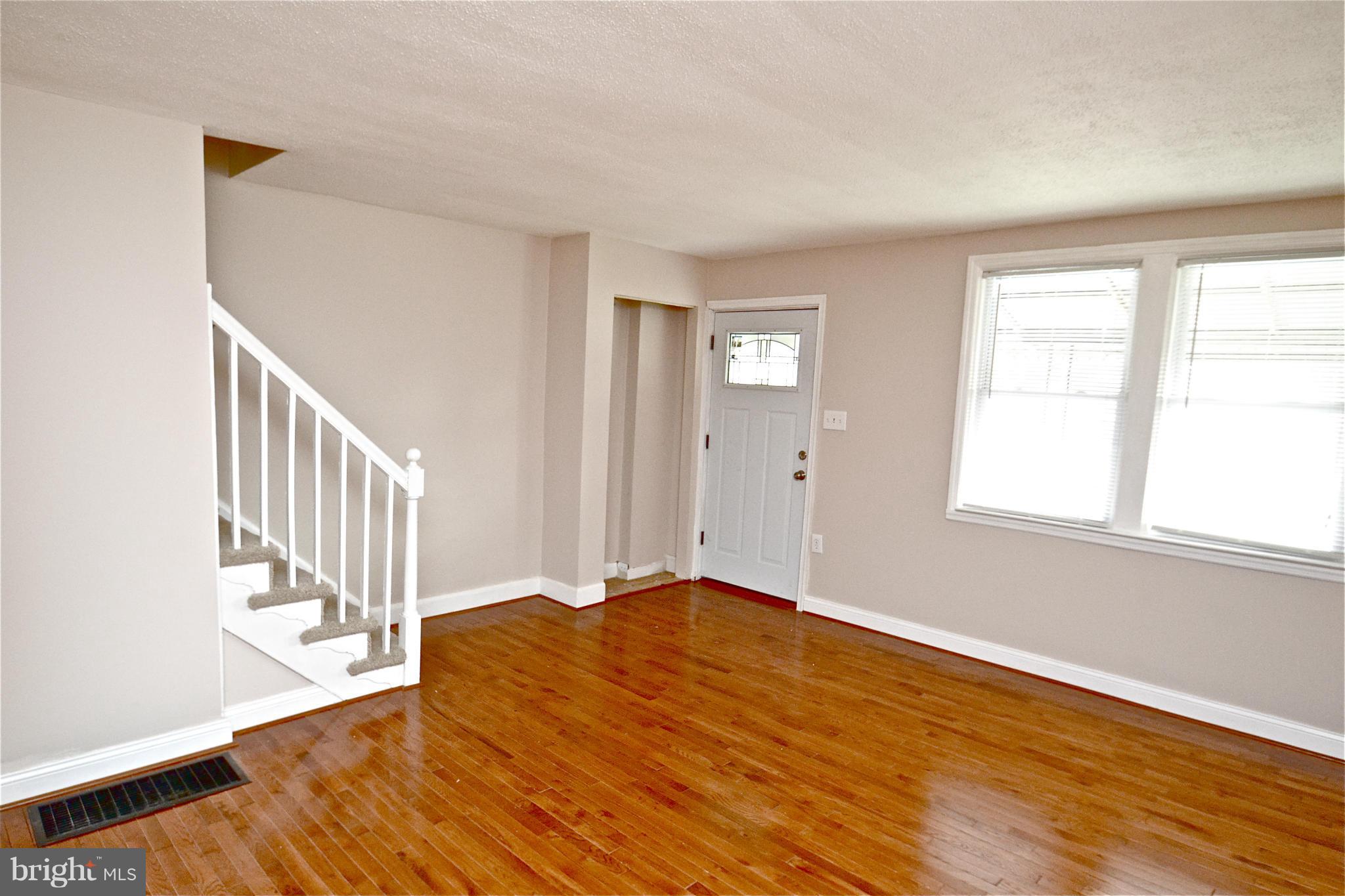 236 West Edgevale Road Baltimore, MD 21225 - Photo 2 of 30 a view of an empty room with wooden floor and a window