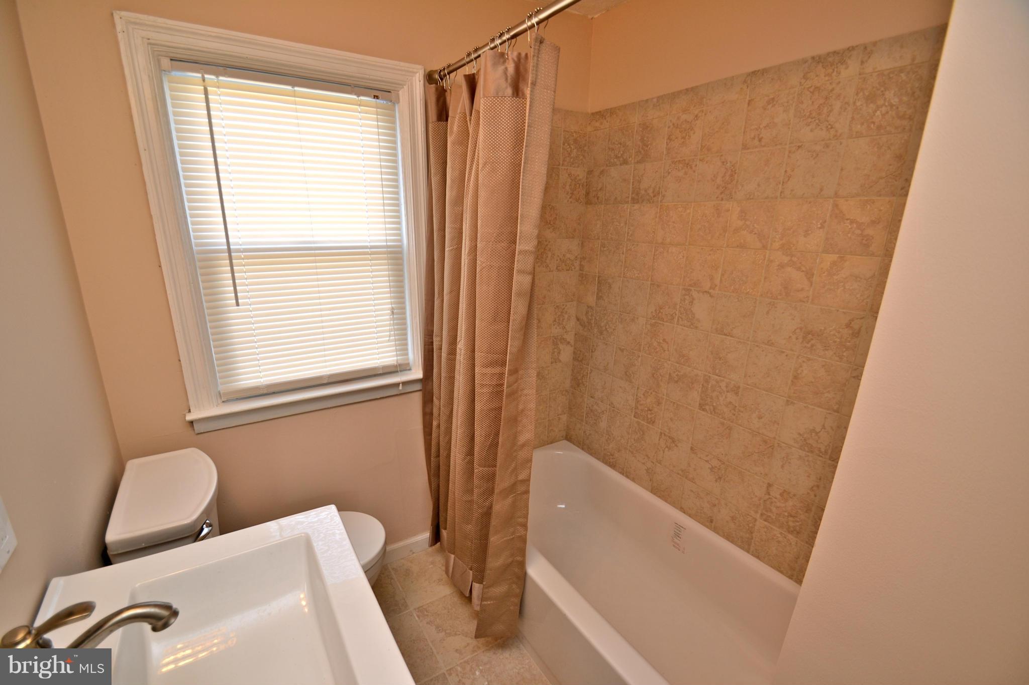 236 West Edgevale Road Baltimore, MD 21225 - Photo 21 of 30 a bathroom with a sink and a bathtub