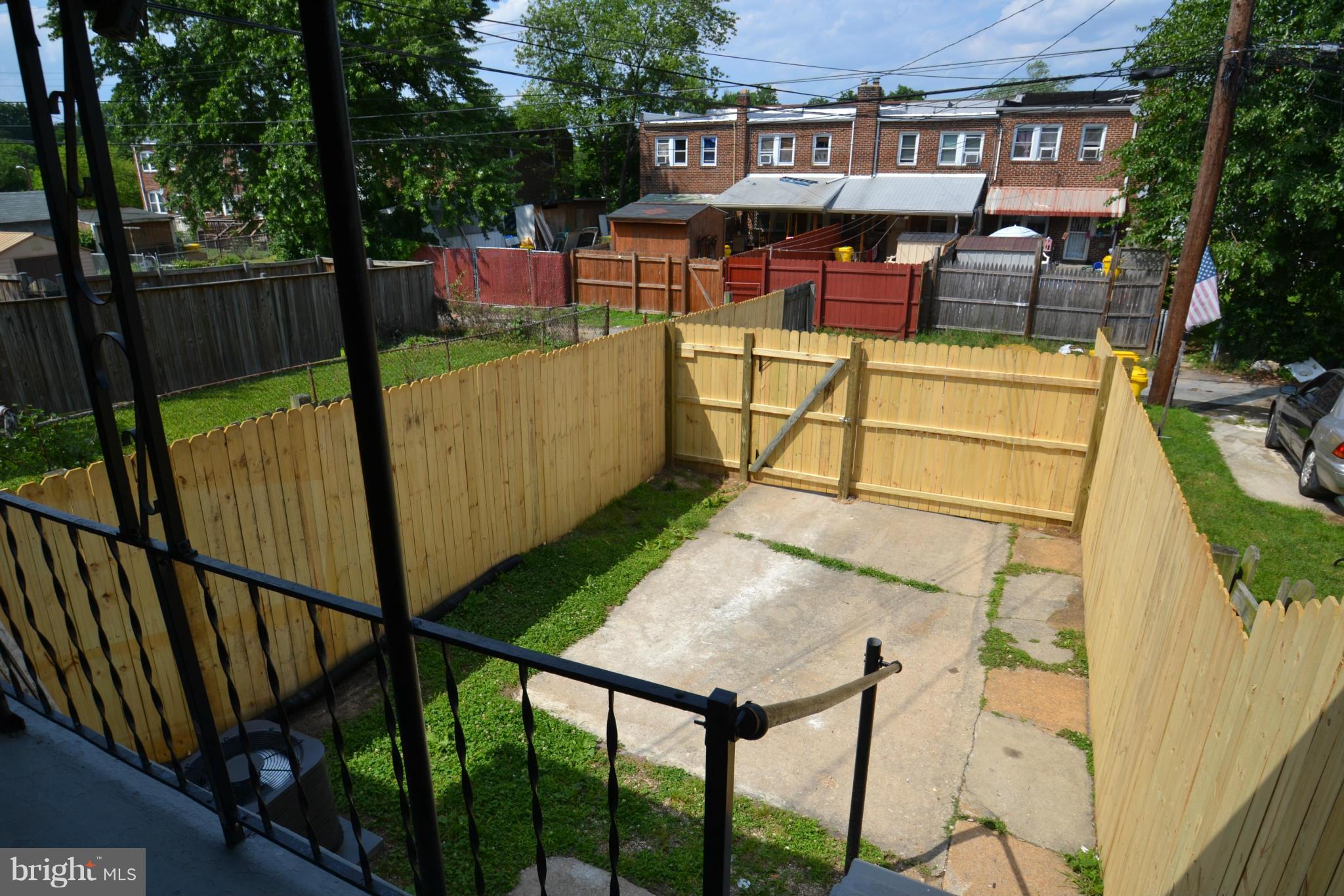 236 West Edgevale Road Baltimore, MD 21225 - Photo 27 of 30 a view of a patio with table and chairs with wooden floor and fence