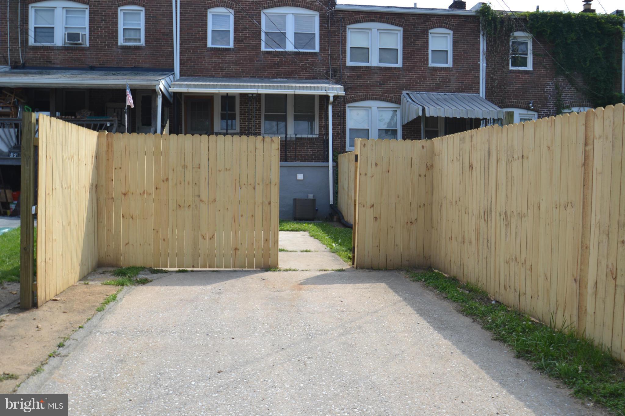 236 West Edgevale Road Baltimore, MD 21225 - Photo 29 of 30 a view of a brick house with wooden fence