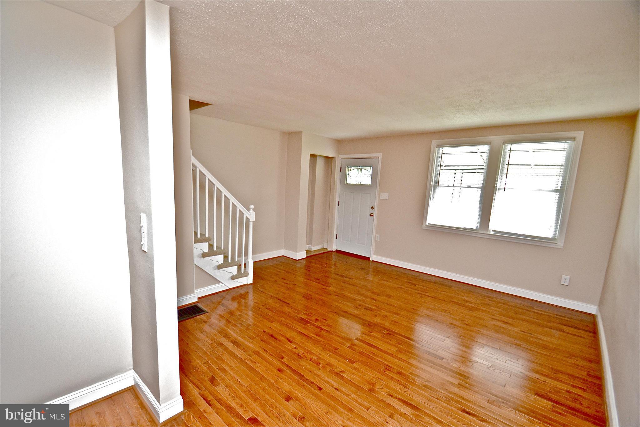 236 West Edgevale Road Baltimore, MD 21225 - Photo 4 of 30 a view of a livingroom with wooden floor and staircase