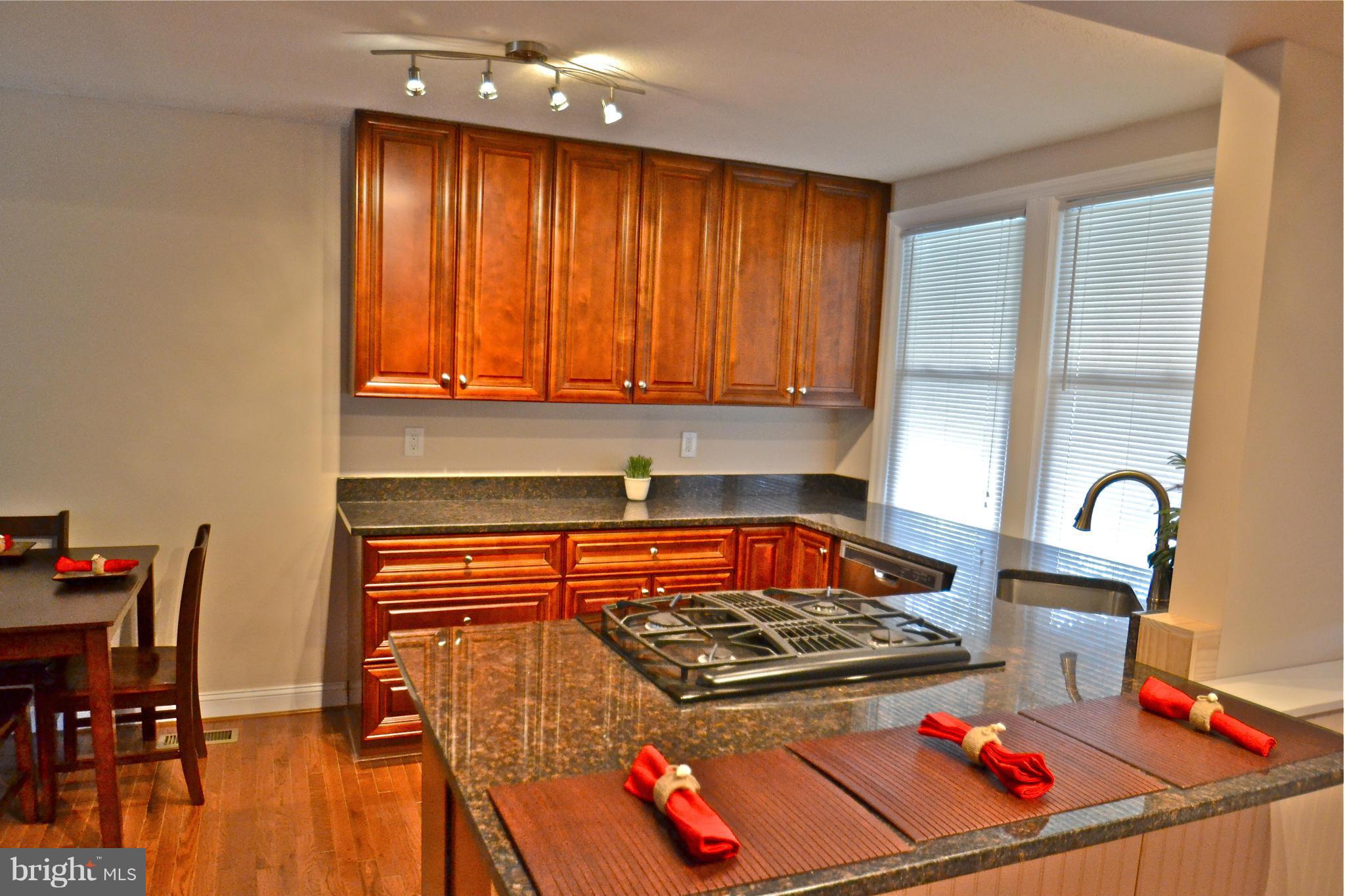 236 West Edgevale Road Baltimore, MD 21225 - Photo 6 of 30 a kitchen with stainless steel appliances granite countertop a stove a sink and a microwave