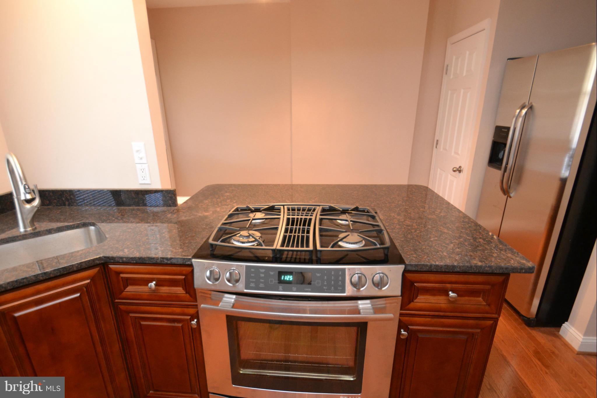 236 West Edgevale Road Baltimore, MD 21225 - Photo 8 of 30 a stove top oven sitting inside of a kitchen