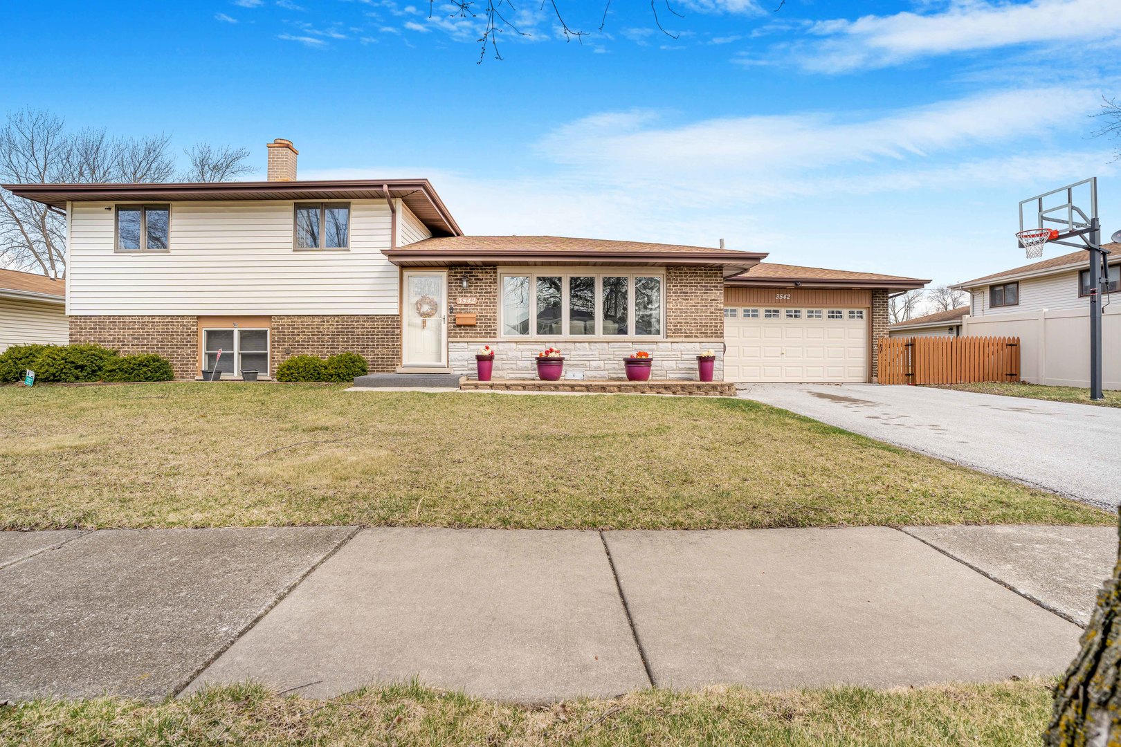 a front view of house with yard and garage