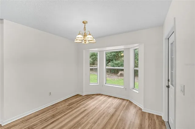 a view of a livingroom with wooden floor and a ceiling fan